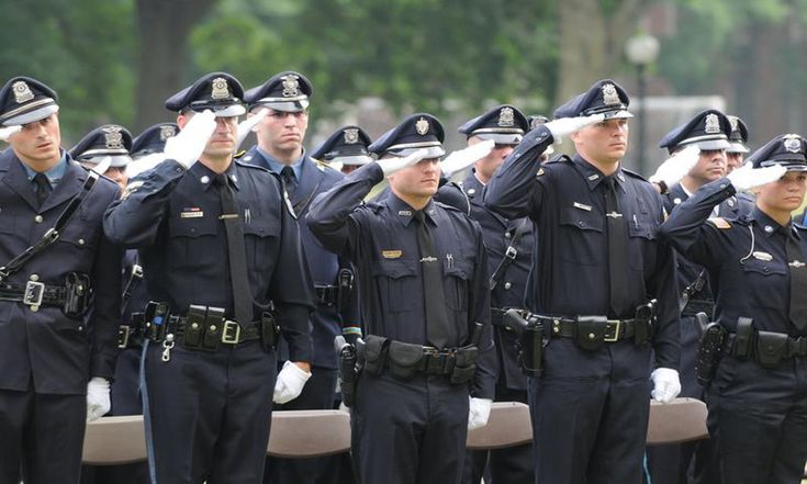 people in uniforms saluting