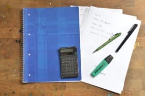 calculator, papers and pens