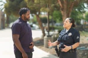 a female police officer talking to a man