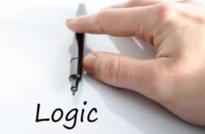 a person pointing a pen to the word LOGIC written on the paper
