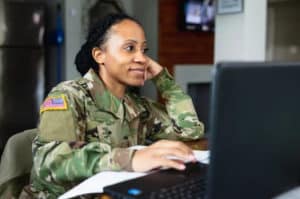 a female soldier in front of the laptop