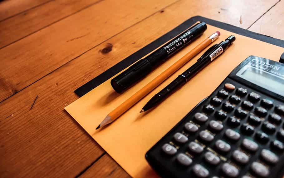 calculator, pen and pencils on the desk