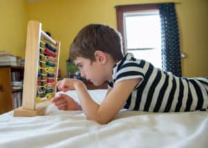 a boy counting on the bed