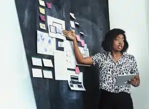 a woman having a presentation in front of the board 