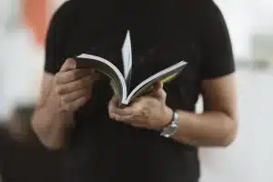 closeup of a man holding a book 