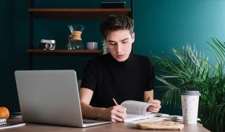 Young Man Studying and Making Notes