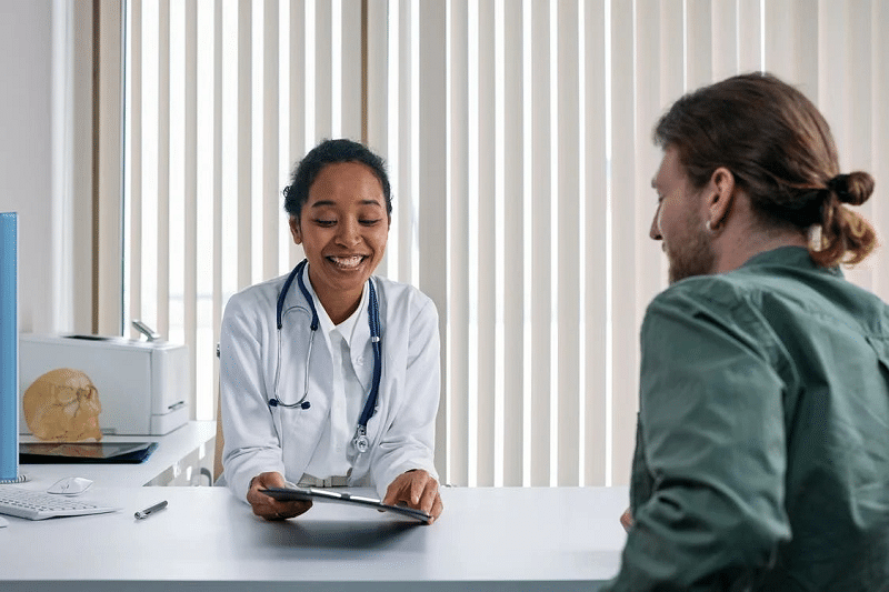 A happy lady Doctor discussing with a Patient