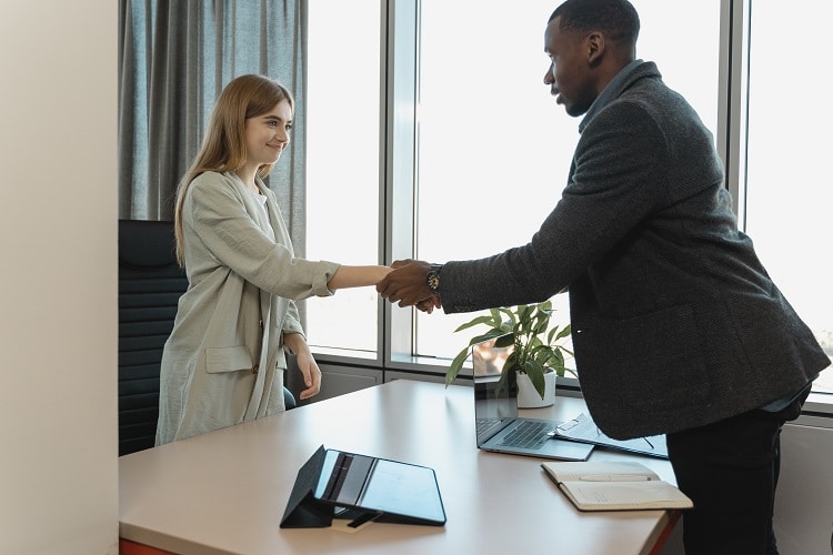 Businessman welcoming a new female employee