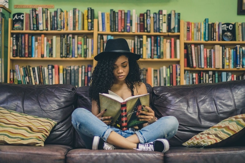 Girl with Curly Hair Reading a Book