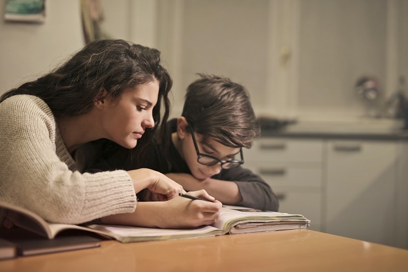 Mother helping kid to Prepare for exam
