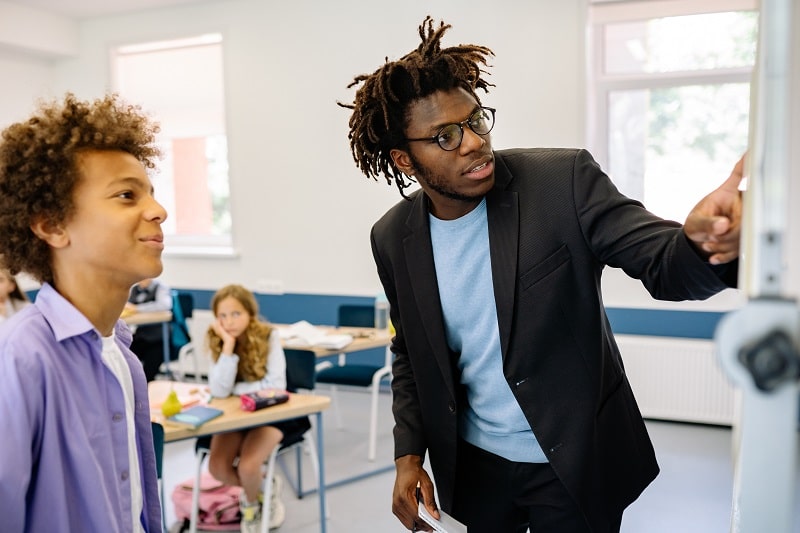 Teacher Showing a Boy the Lesson