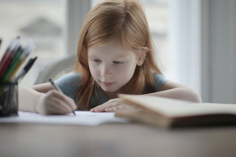 little girl doing homework at home